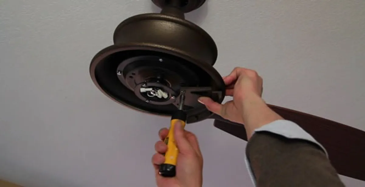 Electrician installing ceiling fan mounting bracket and fixture in Reno, NV